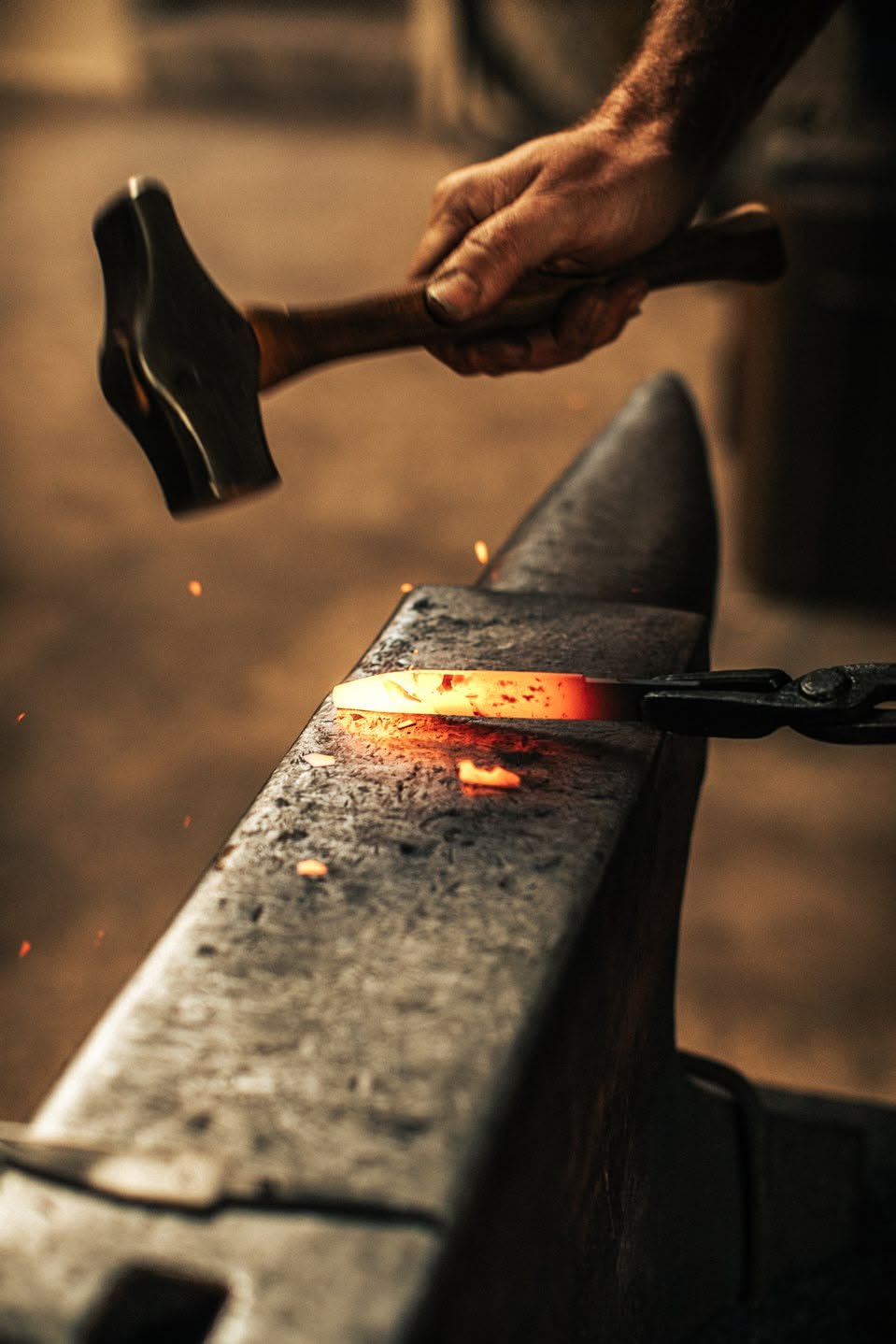 Bladesmith hand-grinding a knife edge